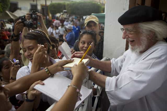Nicaraguan poet, priest and former Minister of Culture of Nicaragua, Ernesto Cardenal, signs autographs during celebrations marking the 9th International Poetry Festival in his honor in Granada, Nicaragua, Wednesday, Feb 20, 2013. The festival is attended by more than 300 poets from some 60 countries. (Photo by Esteban Felix/AP Photo)