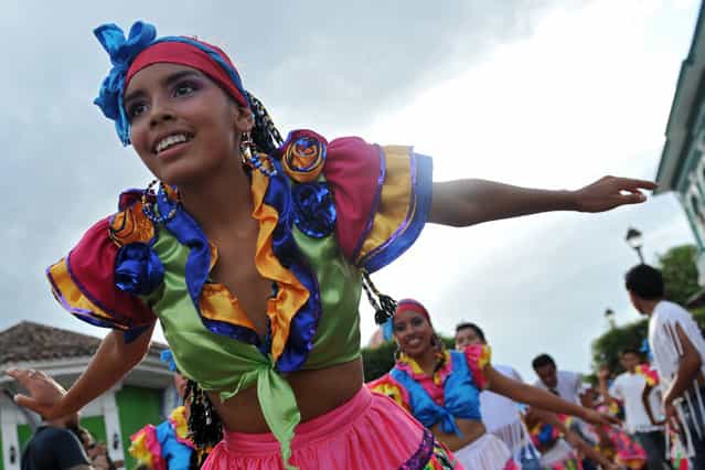 A girl takes part in the [Burial of arrogance and haughtiness] carnival during the IX Poetry Festival in Granada, 45 km from Managua, Nicaragua on February 20, 2013. In this occasion the festival is dedicated to Nicaraguan poet Ernesto Cardenal. (Photo by Hector Retamal/AFP Photo)