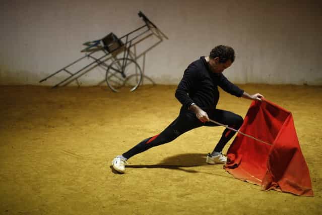 Spanish bullfighter Rafael Tejada performs a pass with a [muleta] (red cape) during a training session on the training arena at Reservatauro Ronda cattle ranch in Ronda, near Malaga February 12, 2013. Spain's parliament voted on Tuesday to consider protecting bullfighting as a national pastime, angering animal rights campaigners and politicians in two regions where the sport is banned. (Photo by Jon Nazca/Reuters)