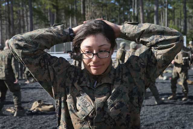 Pfc. Cristiana Alvarez from Milwaukee, Wisconsin works on searching procedures during Marine Combat Training (MCT) on February 20, 2013 at Camp Lejeune, North Carolina. Since 1988 all non-infantry enlisted male Marines have been required to complete 29 days of basic combat skills training at MCT after graduating from boot camp. MCT has been required for all enlisted female Marines since 1997. About six percent of enlisted Marines are female. (Photo by Scott Olson)