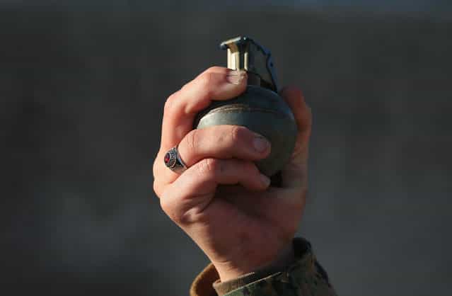 A female Marine prepares to throw a practice grenade during Marine Combat Training (MCT) on February 21, 2013 at Camp Lejeune, North Carolina. Since 1988 all non-infantry enlisted male Marines have been required to complete 29 days of basic combat skills training at MCT after graduating from boot camp. MCT has been required for all enlisted female Marines since 1997. About six percent of enlisted Marines are female. (Photo by Scott Olson)