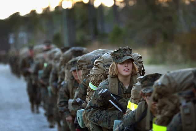 Pfc. Schevlle Woodard from Grand Prairie, Texas prepares to head out on a 15-kilometer night march with male and female Marines during Marine Combat Training (MCT) on February 21, 2013 at Camp Lejeune, North Carolina. Since 1988 all non-infantry enlisted male Marines have been required to complete 29 days of basic combat skills training at MCT after graduating from boot camp. MCT has been required for all enlisted female Marines since 1997. About six percent of enlisted Marines are female. (Photo by Scott Olson)