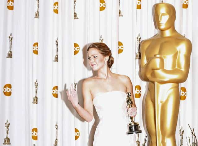 Jennifer Lawrence reacts as she poses backstage with her Oscar after winning the best actress award for her role in [Silver Linings Playbook] at the 85th Academy Awards in Hollywood, California, February 24, 2013. Lawrence reacted to some photographers telling her to watch her step as she went onto the platform. (Photo by Mike Blake/Reuters)