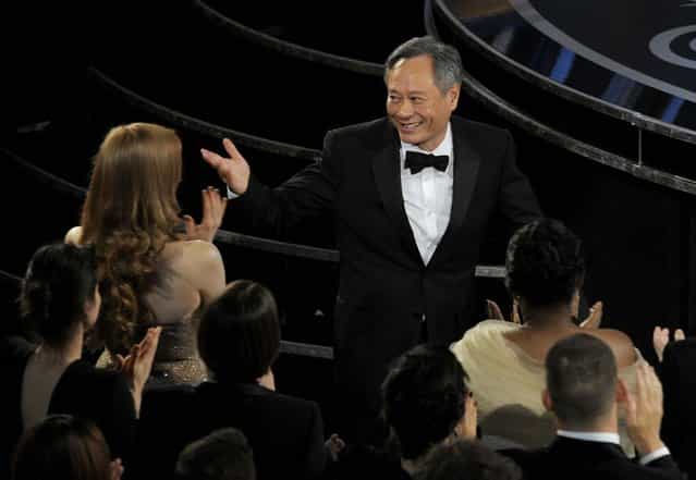 Ang Lee walks on stage to accept the award for best director for [Life of Pi]. (Photo by Chris Pizzello/Invision)