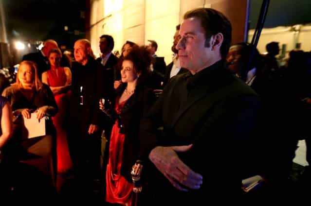 John Travolta, Helena Bonham Carter and others stand backstage. (Photo by Matt Sayles/Invision)