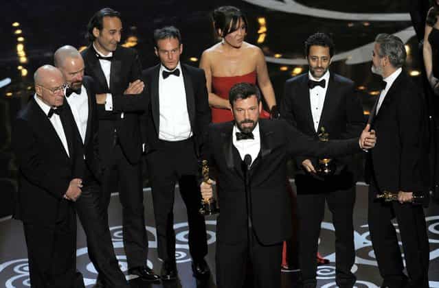 Director/producer Ben Affleck accepts the award for best picture for [Argo] as the cast and crew look on. (Photo by Chris Pizzello/Invision)