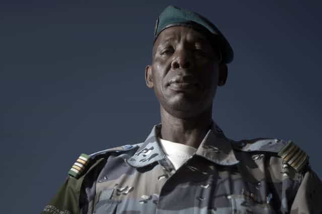 Malian chief of Gao's gendarmerie district, Colonel Salhiou Maiga poses in the office of the Gao's gendarmerie in Gao, on February 24, 2013. After recapturing the north's cities from the Al Qaeda groups that had controlled them since April 2012, the six-week-long French-led offensive took the fight to the retreating Islamist insurgents' toughest desert bastions. (Photo by Joel Saget/AFP Photo/The Atlantic)