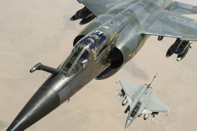 A French Mirage F1CR (top) and a Rafale jetfighter fly over Mali, on February 4, 2013. (Photo by Anthony Jeuland/AP Photo/ECPAD/French Air Force/The Atlantic)
