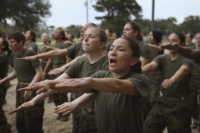 Female Marine recruits are disciplined with some unscheduled physical training in the sand pit outside their barracks during boot camp February 27, 2013 at MCRD Parris Island, South Carolina. Female enlisted Marines have gone through recruit training at the base since 1949. About 11 percent of female recruits who arrive at the boot camp fail to complete the training, which can be physically and mentally demanding. On January 24, 2013 Secretary of Defense Leon Panetta rescinded an order, which had been in place since 1994, that restricted women from being attached to ground combat units. About six percent of enlisted Marines are female. (Photo by Scott Olson/AFP Photo)