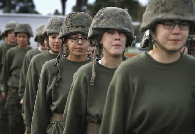 Female Marine recruits get into formation following hand-to-hand combat training during boot camp February 27, 2013 at MCRD Parris Island, South Carolina. Female enlisted Marines have gone through recruit training at the base since 1949. About 11 percent of female recruits who arrive at the boot camp fail to complete the training, which can be physically and mentally demanding. On January 24, 2013 Secretary of Defense Leon Panetta rescinded an order, which had been in place since 1994, that restricted women from being attached to ground combat units. About six percent of enlisted Marines are female. (Photo by Scott Olson/AFP Photo)