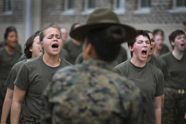 Drill Instructor SSgt. Jennifer Garza disciplines her Marine recruits with some unscheduled physical training in the sand pit outside their barracks during boot camp February 27, 2013 at MCRD Parris Island, South Carolina. Female enlisted Marines have gone through recruit training at the base since 1949. About 11 percent of female recruits who arrive at the boot camp fail to complete the training, which can be physically and mentally demanding. On January 24, 2013 Secretary of Defense Leon Panetta rescinded an order, which had been in place since 1994, that restricted women from being attached to ground combat units. About six percent of enlisted Marines are female. (Photo by Scott Olson/AFP Photo)