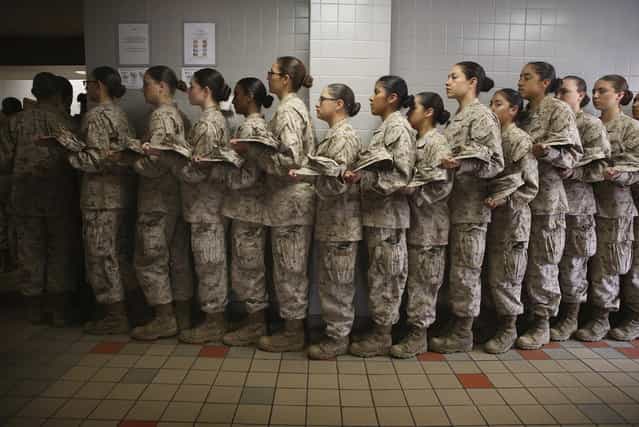 Female Marine recruits stand in line before getting lunch in the chow hall during boot camp on February 26, 2013 at MCRD Parris Island, South Carolina. Female enlisted Marines have gone through recruit training at the base since 1949. About 11 percent of female recruits who arrive at the boot camp fail to complete the training, which can be physically and mentally demanding. On January 24, 2013 Secretary of Defense Leon Panetta rescinded an order, which had been in place since 1994, that restricted women from being attached to ground combat units. (Photo by Scott Olson/AFP Photo)