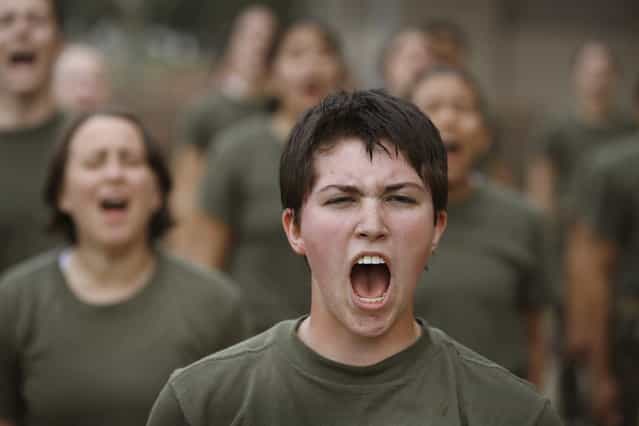 Female Marine recruits respond to their drill instructor as they are disciplined with some unscheduled physical training in the sand pit outside their barracks during boot camp February 27, 2013 at MCRD Parris Island, South Carolina. Female enlisted Marines have gone through recruit training at the base since 1949. About 11 percent of female recruits who arrive at the boot camp fail to complete the training, which can be physically and mentally demanding. On January 24, 2013 Secretary of Defense Leon Panetta rescinded an order, which had been in place since 1994, that restricted women from being attached to ground combat units. About six percent of enlisted Marines are female. (Photo by Scott Olson/AFP Photo)