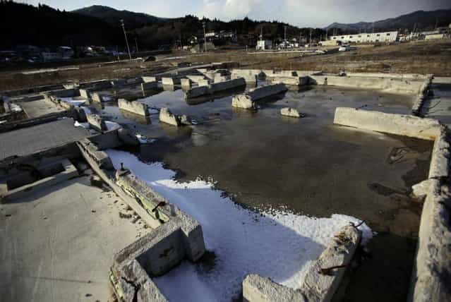 In this Saturday, February 23, 2013 photo, foundations of houses are seen in an area devastated by the March 11, 2011 earthquake and tsunami in Kesennuma, Miyagi Prefecture. Japan's progress in rebuilding from the tsunami that thundered over coastal sea walls, sweeping entire communities away, is mainly measured in barren foundations and empty spaces. Clearing of forests on higher ground due to be leveled to make space for relocating survivors has barely begun. Japan will next week observes two years from the March 11, 2011 disasters which devastated in the northeastern Pacific coast of the country. (Photo by Junji Kurokawa/AP Photo)