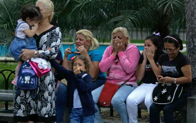 Women, including children, weep after the announcement of the death of Hugo Chávez, President of Venezuela. (Photo by Fernando Llano/AP Photo)