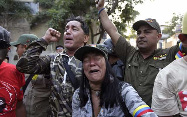 Supporters of Venezuela's President Hugo Chavez react as they learn that Chavez has died through an announcement by the vice president in Caracas, Venezuela, Tuesday, March 5, 2013. Venezuela's Vice President Nicolas Maduro announced that Chavez died on Tuesday at age 58 after a nearly two-year bout with cancer. During more than 14 years in office, Chavez routinely challenged the status quo at home and internationally. He polarized Venezuelans with his confrontational and domineering style, yet was also a masterful communicator and strategist who tapped into Venezuelan nationalism to win broad support, particularly among the poor. (Photo by Ariana Cubillos/AP Photo)