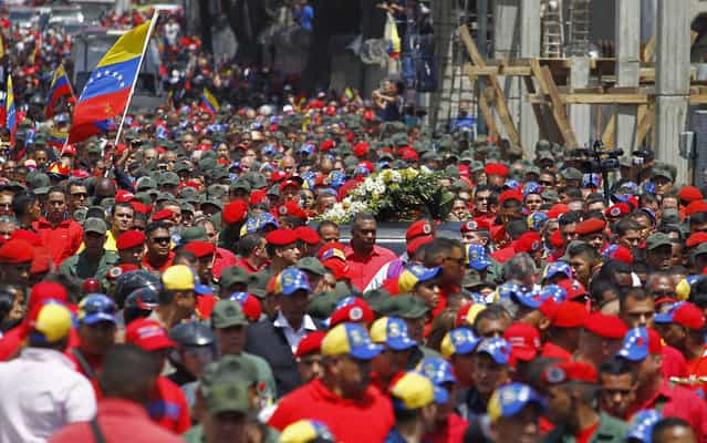 Passage of the coffin with the body of Chavez is accompanied by thousands in Caracas. (Photo by Carlos Garcia Rawlins/Reuters)