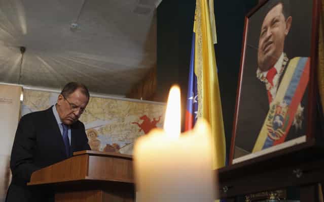 The Russian Foreign Minister, Sergei Lavrov, write in a book of condolence visit to the Embassy of Venezuela in Moscow in tribute to Hugo Chavez. (Photo by Maxim Shemetov/Reuters)