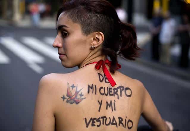 A woman with a message painted on her back that reads in Spainsh [My body, my wardrobe] participates in a demonstration marking International Women's Day in Buenos Aires. (Photo by Victor R. Caivano/Associated Press)