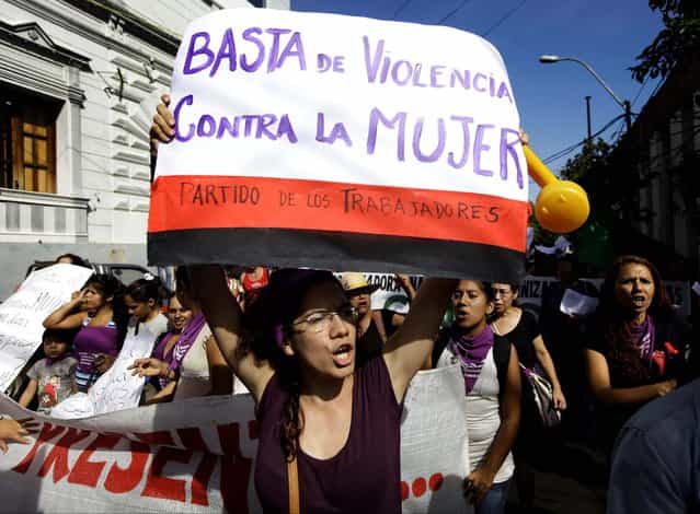 Women shout slogans as they protest violence against women during a march in Asuncion, Paraguay. The poster reads in Spanish [Enough violence against women]. (Photo by Jorge Saenz/Associated Press)