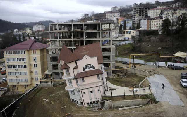 A leaning house in the Russian Black Sea resort of Sochi, Russia, on March 4, 2013. Reason: collapse of the automobile tunnel which built nearby for Winter Olympic Games 2014. (Photo by Mikhail Mordasov/AFP Photo)