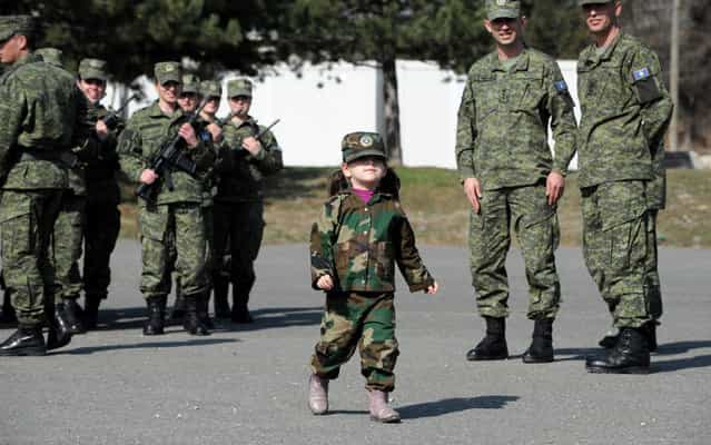 A Kosovo Albanian child dressed in a military costume takes part in a ceremony in Pristina on March 5, 2013 marking the 15th anniversary of the killing of Kosovo Liberation Army (KLA) commander Adem Jashari. Jashari was among 45 members of his family killed by Serb security forces in the vilage of Prekaz some 40 kms west of the Kosovo capital Pristina, sparking a full-blown rebel insurgency. (Photo by Armend Nimani/AFP Photo)