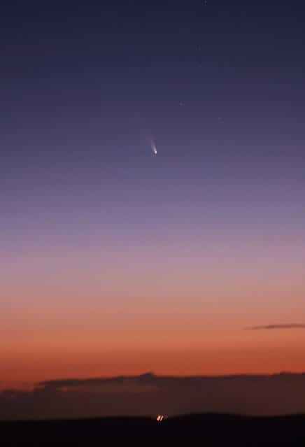 This image provided by NASA shoaws the comet PANSTARRS as seen from Mount Dale, Western Australia on March 5, 2013. According to NASA on March 10, it will make its closest approach to the sun about 28 million miles (45 million kilometers) away. As it continues its nightly trek across the sky, the comet may get lost in the sun's glare but should return and be visible to the naked eye by March 12. (Photo by AP Photo/NASA)