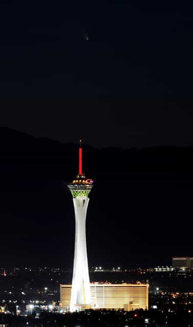 The comet PanSTARRS passes over the Stratosphere Casino Hotel on March 12, 2013 in Las Vegas, Nevada. Officially known as C/2011 L4, the comet got its name after being discovered by astronomers using the Panoramic Survey Telescope & Rapid Response System (Pan-STARRS) telescope in Hawaii in June 2011. (Photo by Ethan Miller)