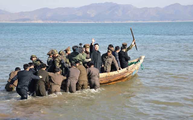 North Korean leader Kim Jong-Un (C) waves while in a boat during his visit to the Wolnae Islet Defence Detachment in the western sector of the front line, which is near Baengnyeong Island of South Korea. South Korea and U.S. forces are conducting large-scale military drills, while the North is also gearing up for a massive military exercise. North Korea has accused the U.S. of using the military drills in the South as a launch pad for a nuclear war and has said to scrap the armistice with the U.S. that ended the 1950-53 Korean War. (Photo by KCNA via Reuters)