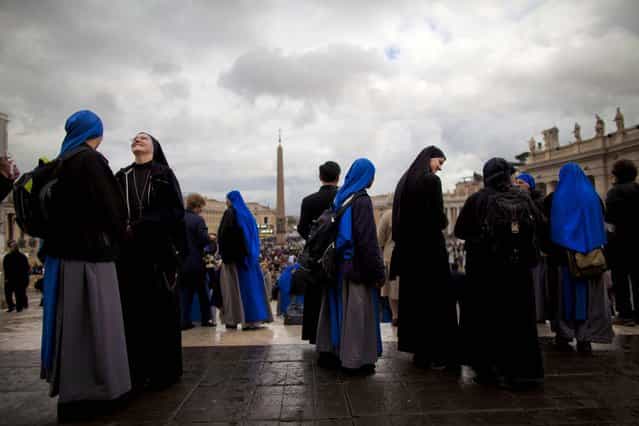 Nuns gather after a Mass for the election of a new pope outside St. Peter's Basilica, at the Vatican, March 12, 2013. (Photo by Oded Balilty/Associated Press)