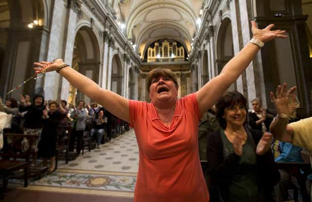 Paola La Rocca celebrates after hearing on the speakers at the Metropolitan Cathedral that Buenos Aires' Archbishop Jorge Bergoglio was chosen as Pope in Buenos Aires, Argentina, Wednesday, March 13, 2013. Bergoglio is the first pope ever from the Americas and the first from outside Europe in more than a millennium. (Photo by Victor R. Caivano/AP Photo)