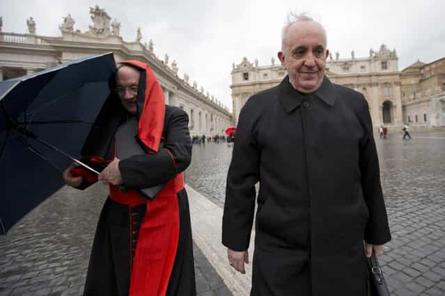 Canadian Cardinal Marc Ouellet, left, holds on to his umbrella next to Argentine Cardinal Jorge Mario Bergoglio as they walk in St. Peter's Square after attending a cardinals' meeting, at the Vatican, Wednesday, March 6, 2013. Cardinals are meeting to discuss the problems of the church and to get to know one another because there is no clear front-runner in the election of the new pope. (Photo by Andrew Medichini/AP Photo)