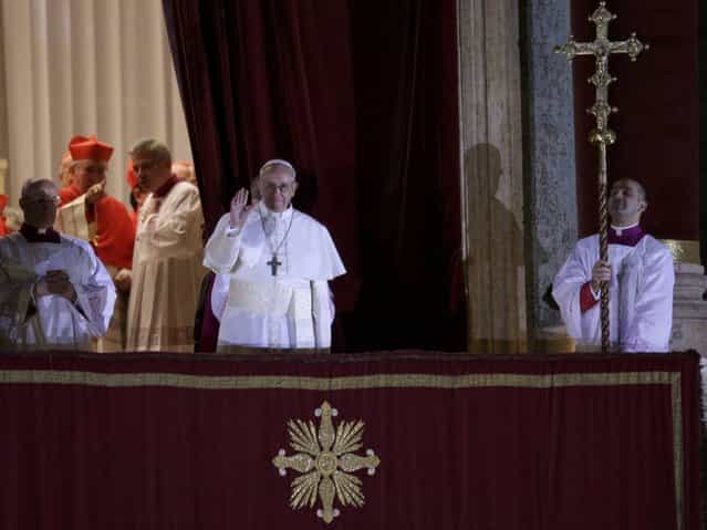 Newly elected Pope Francis, Cardinal Jorge Mario Bergoglio of Argentina appears on the balcony of St. Peter's Basilica after being elected by the conclave of cardinals, at the Vatican, March 13, 2013. White smoke rose from the Sistine Chapel chimney and the bells of St. Peter's Basilica rang out on Wednesday, signaling that Roman Catholic cardinals had elected a pope to succeed Benedict XVI. (Photo by Max Rossi/Reuters)