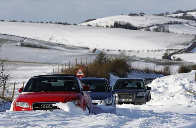 Cars remain stuck in snow on the South Downs near Brighton in southern England March 12, 2013. Drivers were left stranded on Tuesday following a second day of heavy snowfall in southern England. (Photo by Luke MacGregor/Reuters)