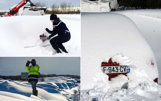 Police digs the snow to identify the license plate of a car after a snowstorm in road near Beaumont-Hague, in northwestern France, on March 13, 2013. More than 68,000 homes were without power in the region, which came on orange alert. (Photo by Alain Jocard/AFP Photo)