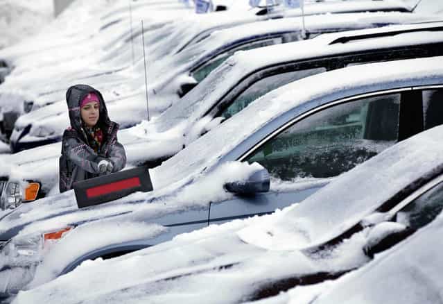 Jessica Halverson, a sales person at Heiser Ford Lincoln dealership on W. Silver Spring Dr. in Milwaukee works on clearing the snow off the cars in the lot on Wednesday, March 6, 2013. Snow piled up across the state Tuesday as a late-season storm with snow totals ranging from 8.9 inches in areas of Dane County to an official 4.1 inches at Mitchell International Airport in Milwaukee, according to the National Weather Service in Sullivan. After pummeling the nation's midsection with heavy snow, the late-winter storm made its way Wednesday to the nation's capital, where residents braced for the possibility of power outages. (Photo by Mike De Sisti/MDESISTI@JOURNALSENTINEL.COM)
