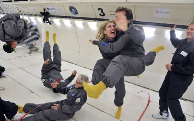 Civilian passengers of the Airbus A330 Zero-G, who are not astronauts nor scientists, enjoy the weightlessness, on March 15, 2013, during the first zero gravity flight for paying passengers in Europe. All boarding cards, costing 6,000 euros, were sold for the years 2013 and 2014. Zero gravity flights for paying passengers have already taken place in the United States and Russia. The zero-gravity of space is simulated by flying a series of parabolic flight maneuvers that counter the forces of gravity and allow astronauts and cosmonauts to learn how to accomplish tasks with no gravity. (Photo by Mehdi Fedouach/AFP Photo)