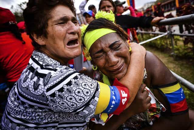 Supporters of the late President Hugo Chavez react after watching the funeral procession in Caracas, on March 15, 2013. (Photo by Meridith Kohut/The New York Times)