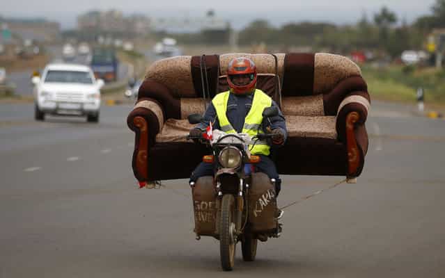 A man carries a sofa on his motorcycle on a highway near Kenya’s capital Nairobi on March 11, 2013. (Photo by Marko Djurica/Reuters)