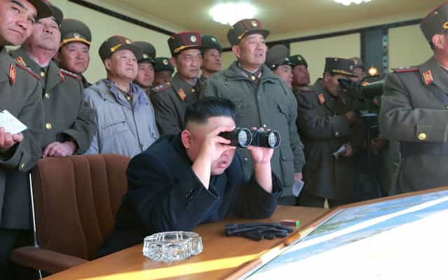 North Korean leader Kim Jong-un (C) and military officers watch a live shell firing drill to examine war fighting capabilities of artillery sub-units, whose mission is to strike DaeYeonpyeong island and Baengnyeong island of South Korea, in the western sector of the front line in this picture released by the North’s official KCNA news agency in Pyongyang, on March 14, 2013. (Photo by KCNA via Reuters)