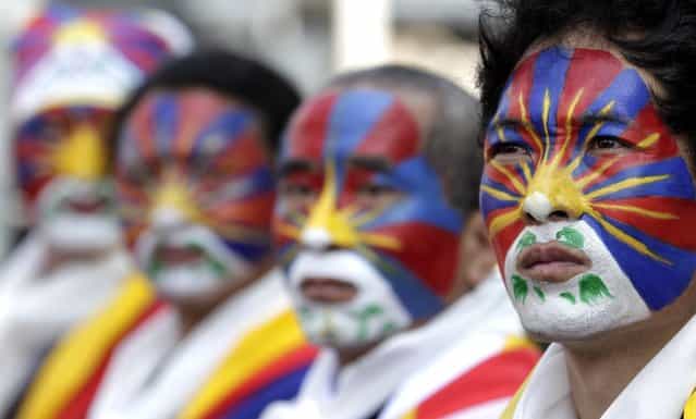 Activists with the colours of the Tibetan flag painted on their faces take part in a rally to support Tibet in Taipei March 10, 2013. Hundreds of Tibetans and their supporters in Taiwan marched the streets to commemorate the uprising in Lhasa 54 years ago against Chinese rule. (Photo by Pichi Chuang/Reuters)