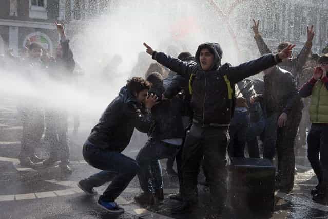 Policemen use water cannons to break up the crowd of protesters during a rally in Baku, March 10, 2013. Police in Azerbaijan fired rubber bullets and water cannon at hundreds of opposition protesters demonstrating on Sunday against violence in the military in the oil-rich country. (Photo by Elmar Mustafazadeh/Reuters)