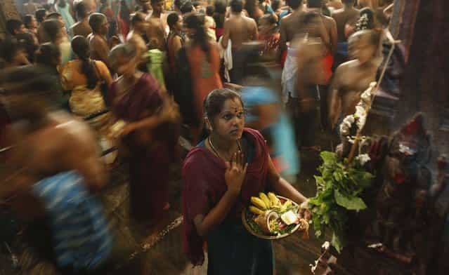 A Hindu devotee prays during the annual Maha Shivaratri festival at Shivam Kovil in Colombo March 10, 2013. Sri Lanka's Hindu devotees celebrate the annual Maha Shivaratri festival by fasting for an entire day and holding a night long vigil at Hindu temples island wide. (Photo by Dinuka Liyanawatte/Reuters)