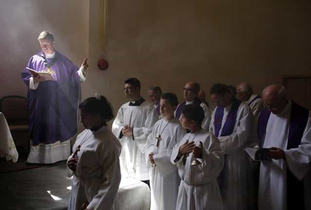 Catholic clergy take part in a morning prayer at the Al-Bishara Church in the West Bank town of Beit Jala, near Bethlehem March 10, 2013. Christian worshippers in the West Bank voiced hope on Sunday that the conclave of Roman Catholic cardinals will swiftly elect a successor to Pope Benedict XVI. (Photo by Ammar Awad/Reuters)