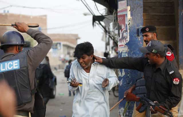 Police beat and detain a Pakistani Christian protester during a demonstration against Saturday's burning of Christian houses and belongings in Badami Bagh, Lahore March 10, 2013. Hundreds of Pakistani Christians took to the streets across the country on Sunday, demanding better protection after a Christian neighbourhood was torched in the city of Lahore a day earlier in connection with the country's controversial anti-blasphemy law. (Photo by Mohsin Raza/Reuters)