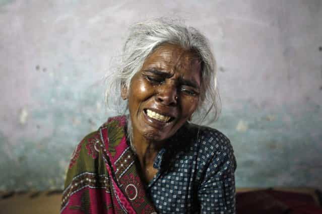 Ram Bai, mother of Ram Singh, the driver of the bus in which a young woman was gang-raped and fatally injured three months ago, wails inside her house at Ravi Das camp in New Delhi March 11, 2013. Ram Singh hanged himself in his jail cell on Monday, prison authorities said, but his family and lawyer said they suspected [foul play]. Singh, the main accused in India's most high-profile criminal case, killed himself in a cell he shared with three other inmates in New Delhi's Tihar jail just before dawn, prison spokesman Sunil Gupta said. Ravi Das camp is the slum where four of the six accused in the rape case including Singh reside at. (Photo by Mansi Thapliyal/Reuters)