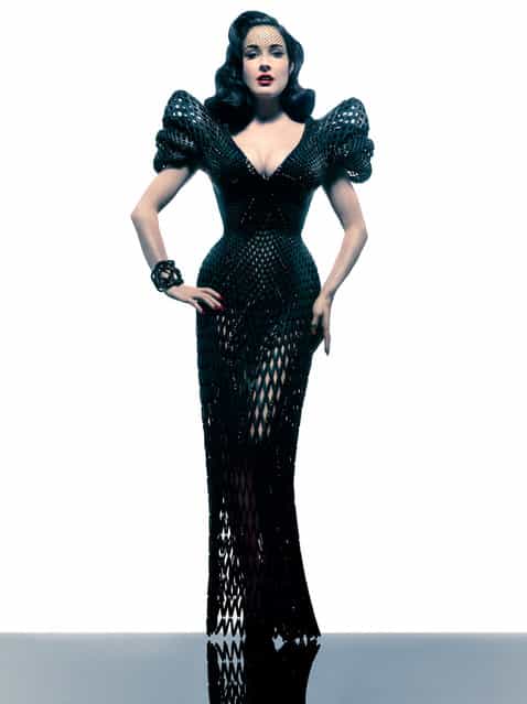 New York designer Michael Schmidt and architect Francis Bitonti have created a 3D-printed dress for burlesque dancer Dita Von Teese. The floor-length nylon gown was made using selective laser sintering (SLS), where material is built up in layers from plastic powder fused together with a laser. The rigid plastic components are fully articulated to create a netted structure that allows for movement. Spirals based on the Golden Ratio were applied to a computer rendering of Von Teese's body so the garment fits her exactly. (Photo by Jeff Meltz)