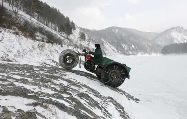 Alexander Yushkov, 49, a boiler room operator in a local mining company, drives his self-made three-wheeled cross-country vehicle called [Bolivar] near the frozen Mana river in a remote taiga area, some 60 km (37 miles) southeast of Russia's Siberian city of Krasnoyarsk March 11, 2013. Yushkov created the vehicle for off-road travel across the taiga through all possible weather conditions by modifying and reconstructing a 1971 Soviet made [Izh Planeta] motorcycle. (Photo by Ilya Naymushin/Reuters)