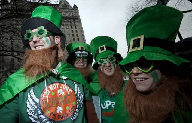 Alan Fitzpatrick (L) from Ireland watches the St. Patrick's Day Parade in New York, March 16, 2013. (Photo by Carlo Allegri/Reuters)
