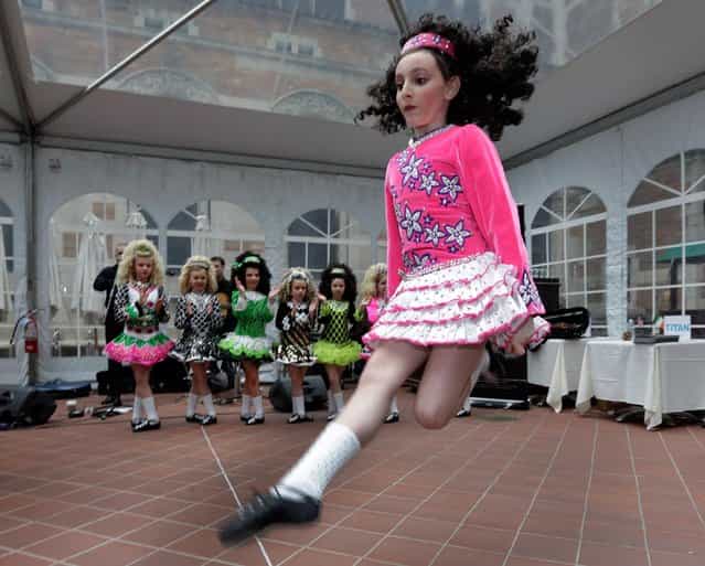Members of the Petri School of Irish Dance perform at the Ireland Chamber of Commerce 17th annual St. Patrick's Day Breakfast, in New York, Saturday, March 16, 2013. The Irish, their descendants and the Irish for the day prepared to don green and pay tribute to Hibernian heritage as a weekend of St. Patrick's Day celebrations was set from New York's Fifth Avenue to the Louisiana bayou to Dublin's Parnell Square. (Photo by Richard Drew/AP Photo)